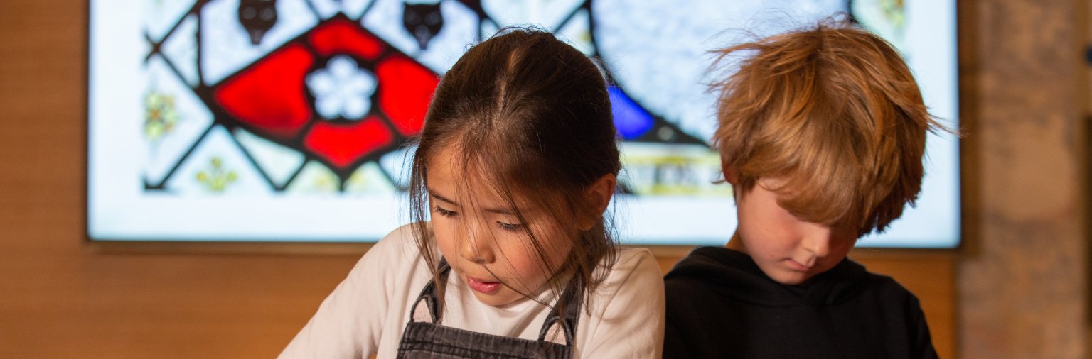 Two children doing crafts at Bath Abbey