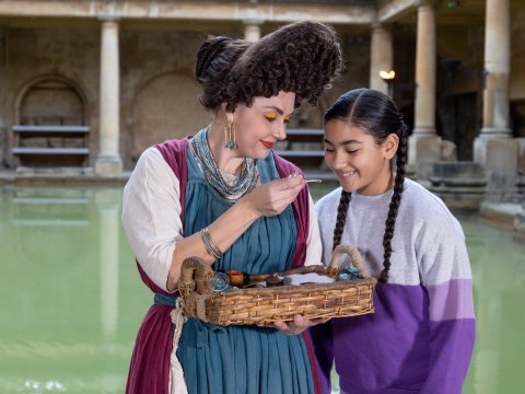 A young girl meeting a Roman Character in The Roman Baths