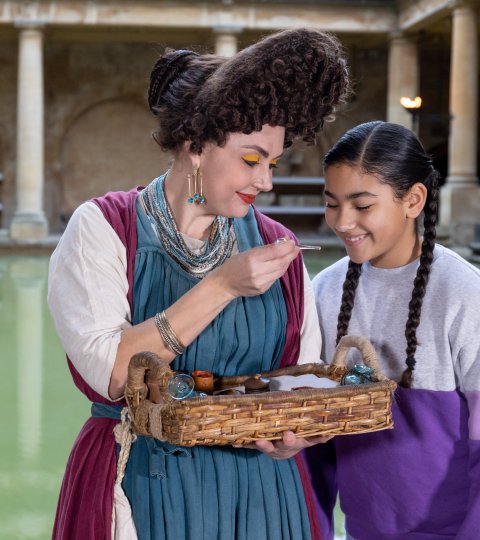 A young girl meeting a Roman Character in The Roman Baths